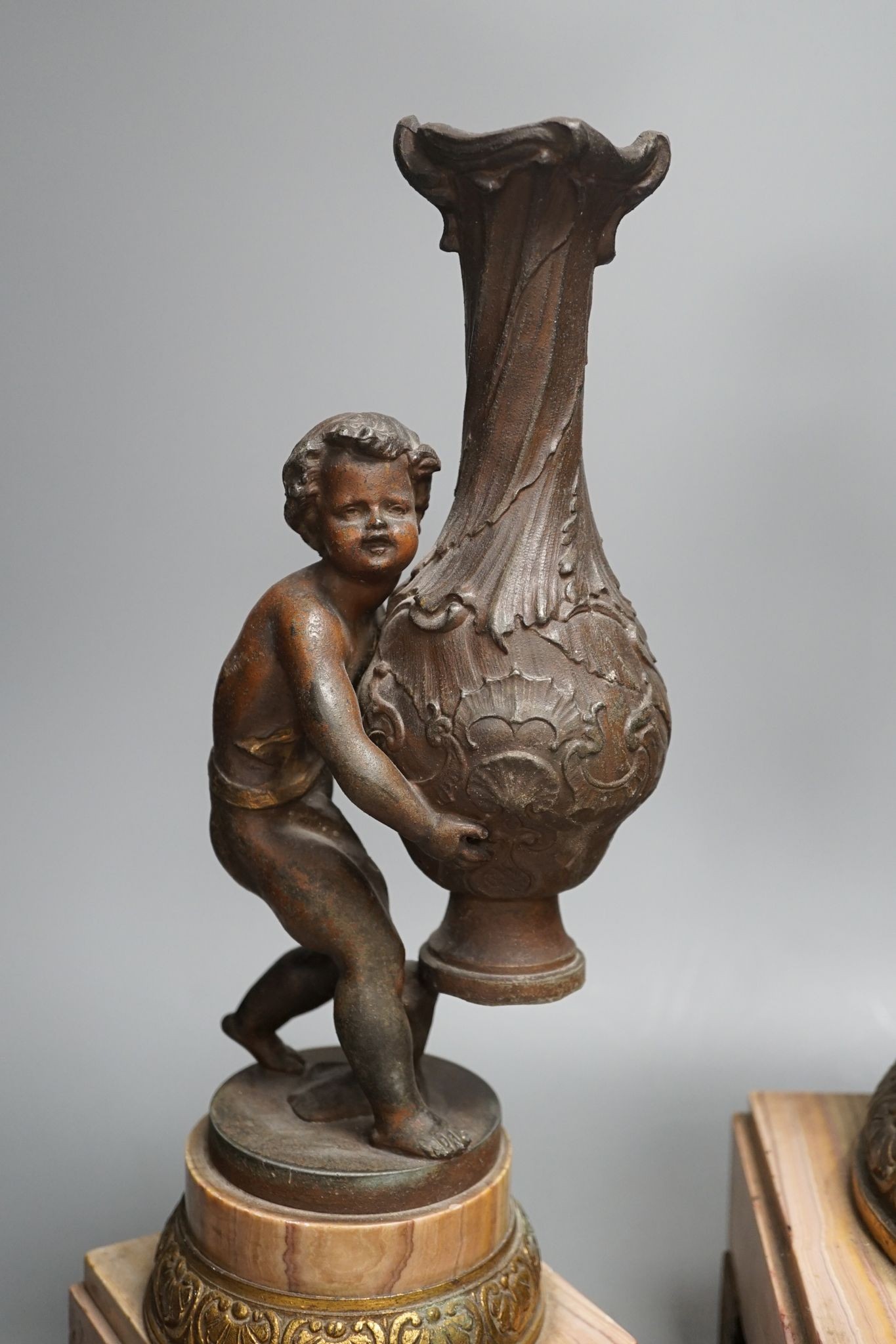 A spelter and marble figural mantel clock and a matching vase 47cm